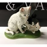 An attractive porcelain figure of a cat with kitte