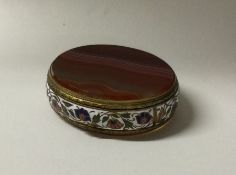 A banded agate and enamel decorated oval pill box.