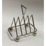 A stylish silver plated toast rack together with s