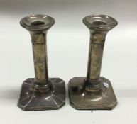 A pair of square shaped silver candlesticks. Birmi