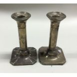 A pair of square shaped silver candlesticks. Birmi
