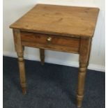 A pine single drawer side table on turned supports