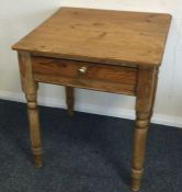A pine single drawer side table on turned supports