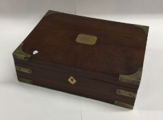 A brass mounted box with inlaid decoration. Est. £