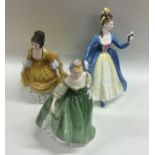 A group of three Royal Doulton figures of ladies.