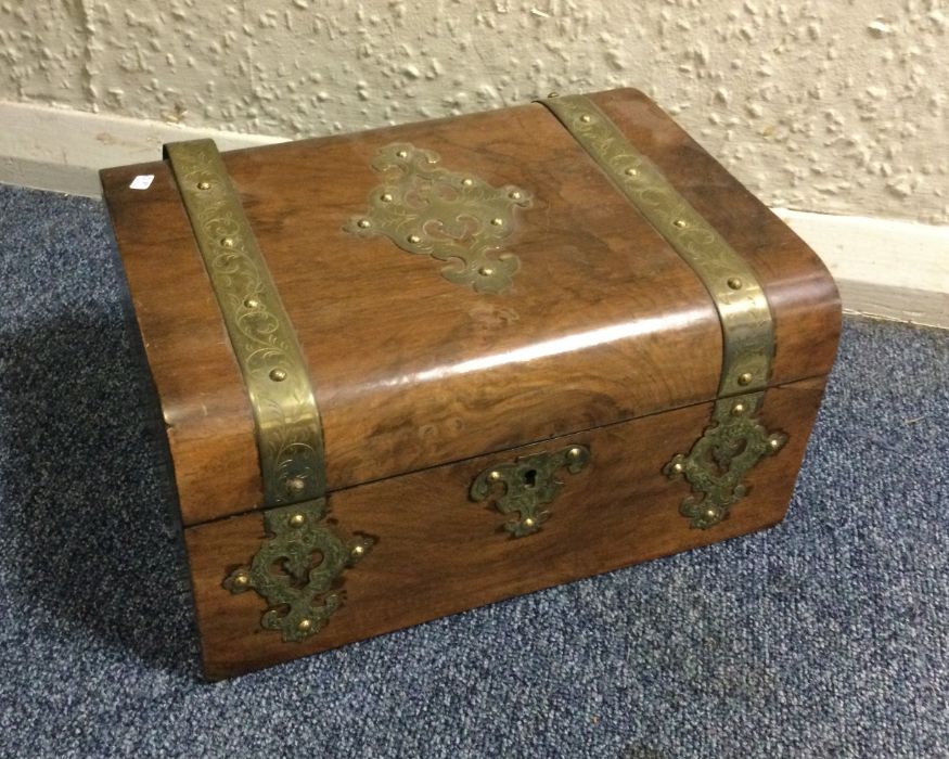A walnut and brass inlaid box with fitted interior