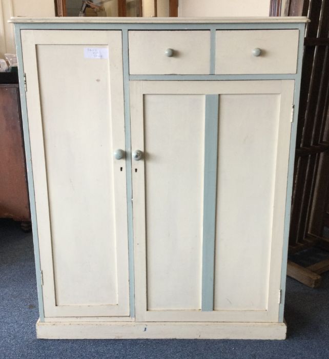 A painted pine two drawer cupboard on pedestal bas