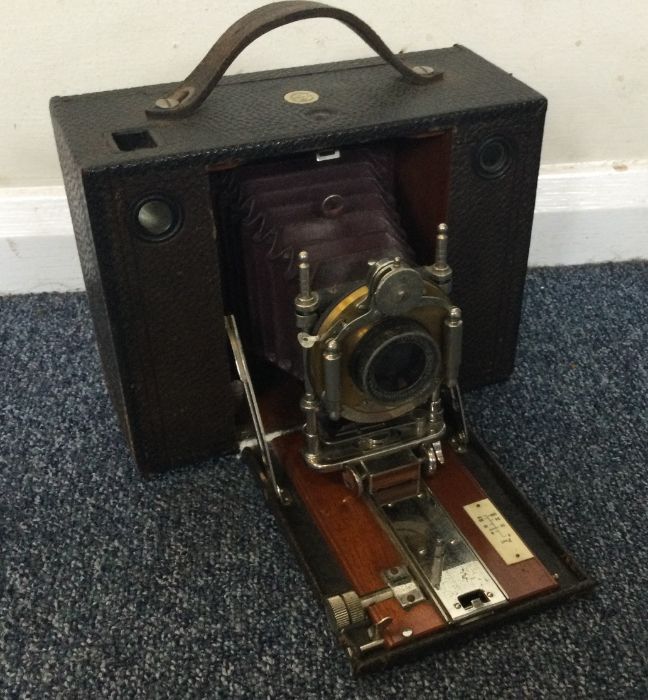 An old cased camera and lens by Kodak. Est. £30 -