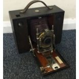 An old cased camera and lens by Kodak. Est. £30 -