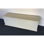 A white painted hinged top trunk. Est. £40 - £60.