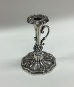 A Victorian silver chamber stick with leaf decorat