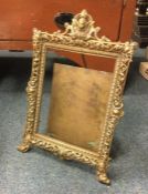 A large brass picture frame with pierced decoratio