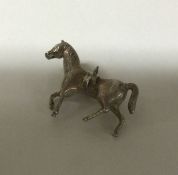 A heavy cast silver figure of a horse in standing