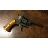 An Antique revolver. Est. £40 - £60.
