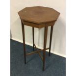 A shaped top occasional table with stretcher base.