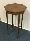 A shaped top occasional table with stretcher base.