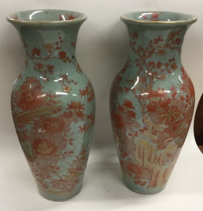 A good pair of Chinese vases decorated with red fl