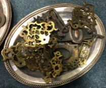 A tray containing brass and other door furniture.