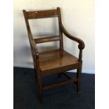 A Georgian oak hall chair. Est. £30 - £50.