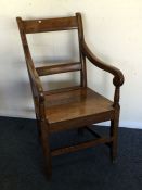 A Georgian oak hall chair. Est. £30 - £50.