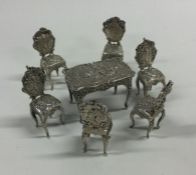 A good set of six silver miniature chairs embossed