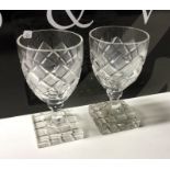 A pair of heavy cut glass tumblers on square bases