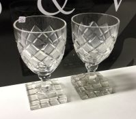 A pair of heavy cut glass tumblers on square bases