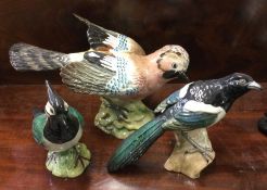 A Beswick figure of a jay together with two others