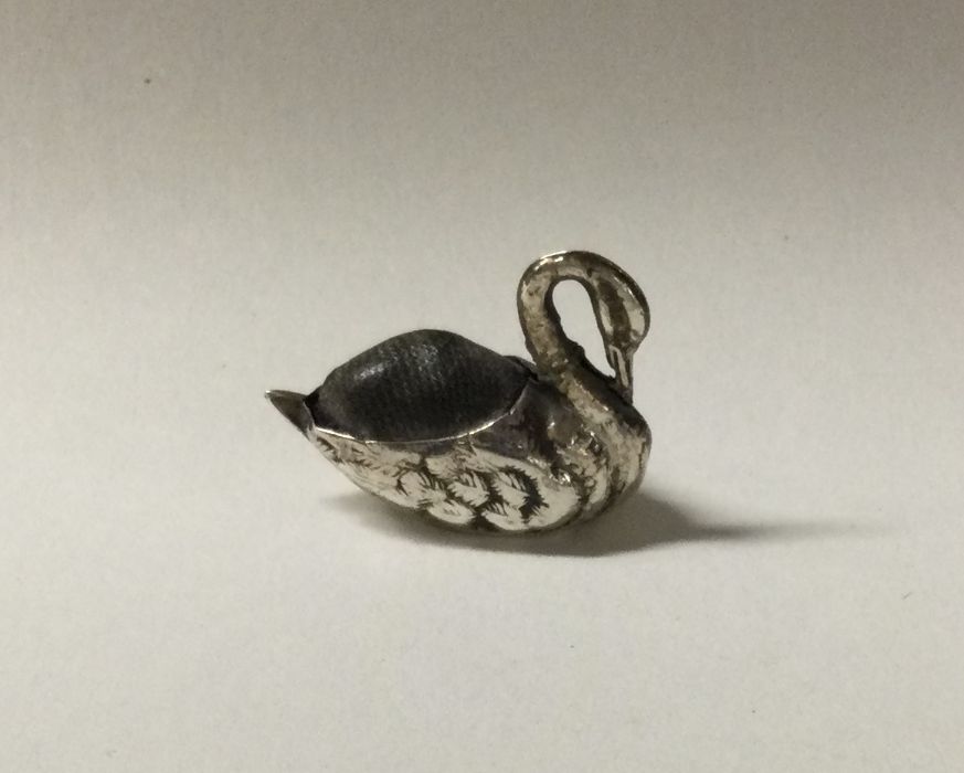 A small silver pin cushion in the form of a swan.