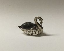 A small silver pin cushion in the form of a swan.