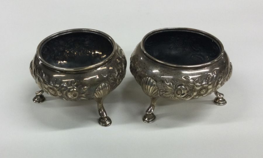 A pair of Georgian silver circular salts decorated