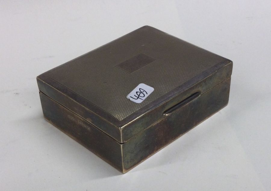 An Edwardian silver cigarette box with engine turn