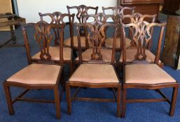 A set of eight Chippendale style dining chairs wit