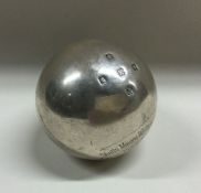 A heavy silver bowling jack with engraved decorati