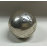 A heavy silver bowling jack with engraved decorati