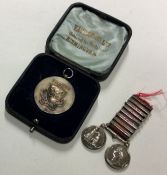 A small silver medallion together with a pair of s