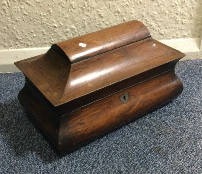 A shaped rosewood mounted tea caddy with hinged li