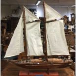 An old wooden pond yacht. Est. £50 - £80.