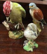 A Beswick figure of a woodpecker together with two