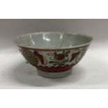 A Chinese baluster shaped bowl decorated in red gr