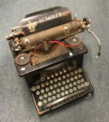 An old LS Smith typewriter. Est. £10 - £20.