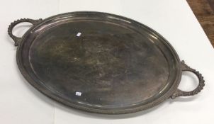 A heavy oval silver two handled tray with gadroon