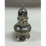 A Continental silver sugar caster with chased deco