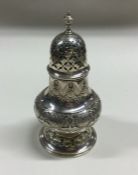 A Continental silver sugar caster with chased deco