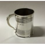 A Victorian tapering silver mug of reeded design.