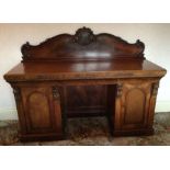 A good quality Victorian mahogany carved twin pede