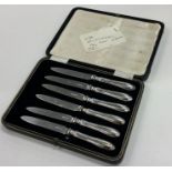 A cased set of six silver handled cake knives. Est