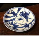 A Chinese blue and white saucer decorated with fig