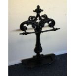 A cast iron stick stand with scroll decoration. Es