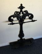 A cast iron stick stand with scroll decoration. Es